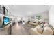 Inviting living room open to kitchen with large windows, plush seating, and stylish decor at 11625 Tetrafin Dr, Riverview, FL 33579