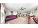 Inviting loft space with carpeted floors, ceiling fan, and comfortable seating arrangements at 11625 Tetrafin Dr, Riverview, FL 33579