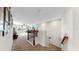 Open and airy loft space featuring a wrought iron staircase and carpeted floors at 11625 Tetrafin Dr, Riverview, FL 33579