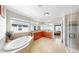Bright bathroom with a soaking tub, separate shower, double sinks, and wood cabinets at 11625 Tetrafin Dr, Riverview, FL 33579
