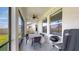 Covered outdoor patio featuring a dining table, ceiling fan, and Weber grill at 11625 Tetrafin Dr, Riverview, FL 33579