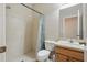 Bright bathroom featuring a tiled walk-in shower, toilet, and vanity with ample counter space at 11716 Summer Springs Dr, Riverview, FL 33579
