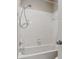 Clean bathroom with a white tiled shower, neutral walls, and modern fixtures at 11716 Summer Springs Dr, Riverview, FL 33579