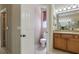Bathroom featuring a wooden vanity, toilet, and window with blinds at 11716 Summer Springs Dr, Riverview, FL 33579