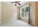 Bright bedroom with large window, neutral carpet, ceiling fan, and ample natural light at 11716 Summer Springs Dr, Riverview, FL 33579