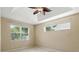 Bedroom featuring carpeted floors, a tray ceiling with ceiling fan, and a large window at 11716 Summer Springs Dr, Riverview, FL 33579