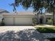 Charming single-story home featuring a three-car garage, manicured lawn, and beautiful landscaping at 11716 Summer Springs Dr, Riverview, FL 33579