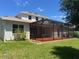 Outdoor view of the house, showing the backyard with a spacious, screened-in patio at 11716 Summer Springs Dr, Riverview, FL 33579