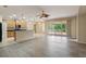 Open concept kitchen with an island, sleek countertops, and sliding glass doors leading to a patio at 11716 Summer Springs Dr, Riverview, FL 33579