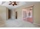 Spacious main bedroom with carpet, a tray ceiling with ceiling fan, and sliding door access to a patio at 11716 Summer Springs Dr, Riverview, FL 33579