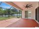 Screened-in patio with concrete floor and access to the backyard with white picket fence at 11716 Summer Springs Dr, Riverview, FL 33579
