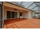 Enclosed patio with ceiling fan, concrete flooring, and access to backyard at 11716 Summer Springs Dr, Riverview, FL 33579