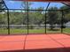 Screened in patio with a backyard view of grass, trees, and a white picket fence at 11716 Summer Springs Dr, Riverview, FL 33579