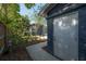 Exterior view of backyard with walkway leading to screened in porch, patio, and garden at 121 W Mohawk Ave, Tampa, FL 33604