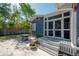 Backyard features a stone patio, outdoor seating, landscaping, and a screened in porch at 121 W Mohawk Ave, Tampa, FL 33604