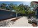 Landscaped backyard with a stone patio and seating, perfect for outdoor dining and entertaining at 121 W Mohawk Ave, Tampa, FL 33604