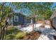 Beautiful backyard with a stone patio, dining table, and lush landscaping, creating a private outdoor oasis at 121 W Mohawk Ave, Tampa, FL 33604