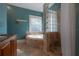 Bathroom featuring a tub and glass block shower at 121 W Mohawk Ave, Tampa, FL 33604