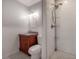 Modern bathroom with a white vanity, granite countertops, and a stylish tile shower at 121 W Mohawk Ave, Tampa, FL 33604