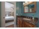 Stylish bathroom featuring a granite vanity with wood cabinets and view to bedroom at 121 W Mohawk Ave, Tampa, FL 33604