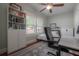 Cozy bedroom with great light, hardwood floors, a ceiling fan, and a decorative rug at 121 W Mohawk Ave, Tampa, FL 33604