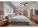 Comfortable bedroom with a ceiling fan, large windows, and hardwood floors creating a cozy retreat at 121 W Mohawk Ave, Tampa, FL 33604