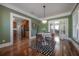 Inviting dining room with hardwood floors, a modern light fixture and adjacent rooms for seamless flow at 121 W Mohawk Ave, Tampa, FL 33604