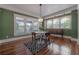 Cozy dining room with hardwood floors, and a round table, creating a welcoming space for dining and conversation at 121 W Mohawk Ave, Tampa, FL 33604
