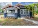 Charming craftsman home featuring a lovely front porch and manicured landscaping at 121 W Mohawk Ave, Tampa, FL 33604
