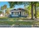 Charming craftsman home with mature trees, a lovely front porch, and inviting curb appeal at 121 W Mohawk Ave, Tampa, FL 33604
