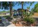 Craftsman home with inviting front porch framed by mature trees and landscape at 121 W Mohawk Ave, Tampa, FL 33604