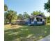 Well-maintained home displays lush lawn, mature trees, a fenced yard, and inviting craftsman-style architecture at 121 W Mohawk Ave, Tampa, FL 33604