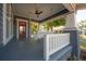Enjoy the outdoor breeze on this home's porch, complete with a swing, ceiling fan and painted floor at 121 W Mohawk Ave, Tampa, FL 33604