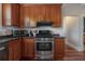 Kitchen featuring stainless steel oven and granite countertop, complemented by rich wood cabinetry at 121 W Mohawk Ave, Tampa, FL 33604