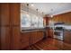 Well-lit kitchen featuring stainless steel appliances, wood cabinets, and granite countertops at 121 W Mohawk Ave, Tampa, FL 33604