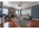 Spacious living room with a brick fireplace, hardwood floors, and ample natural light, creating a welcoming atmosphere at 121 W Mohawk Ave, Tampa, FL 33604