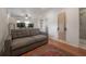 Inviting living room featuring hardwood floors, a comfortable couch, and wall-mounted exercise equipment at 121 W Mohawk Ave, Tampa, FL 33604