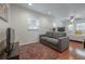 Bonus Room with hardwood floors, television, and comfortable seating area with daybed at 121 W Mohawk Ave, Tampa, FL 33604