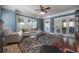 Bright living room with a large window, hardwood floors, and neutral furniture, providing a comfortable living space at 121 W Mohawk Ave, Tampa, FL 33604