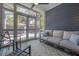 Screened-in porch with comfortable seating and views of the landscaped backyard at 121 W Mohawk Ave, Tampa, FL 33604
