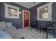 Covered porch features comfortable seating, a geometric rug, and stylish outdoor lighting at 121 W Mohawk Ave, Tampa, FL 33604