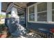 Relaxing front porch with ceiling fan, swing, and ample natural light at 121 W Mohawk Ave, Tampa, FL 33604