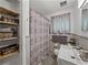 Bathroom features a modern vanity, patterned shower curtain, and gray tile at 131 Oak Park Ave, Brooksville, FL 34601