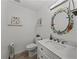 Coastal bathroom features a decorative mirror and white marble counter vanity at 131 Oak Park Ave, Brooksville, FL 34601