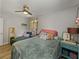 Bedroom with hardwood floors, ceiling fan, daybed and colorful decor at 131 Oak Park Ave, Brooksville, FL 34601