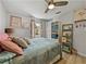 Bedroom featuring hardwood floors, ceiling fan, shelving and colorful decor at 131 Oak Park Ave, Brooksville, FL 34601