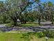 Scenic front yard featuring mature trees covered with Spanish moss along a quiet street at 131 Oak Park Ave, Brooksville, FL 34601