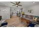 Bright living room featuring a gray couch, wood floors, and ceiling fan at 131 Oak Park Ave, Brooksville, FL 34601