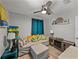 Comfortable living room featuring light gray walls, a ceiling fan, stylish pillows, and light-colored wood-look flooring at 131 Oak Park Ave, Brooksville, FL 34601