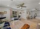Open-concept living room with hardwood floors, stylish seating, and ample natural light at 131 Oak Park Ave, Brooksville, FL 34601